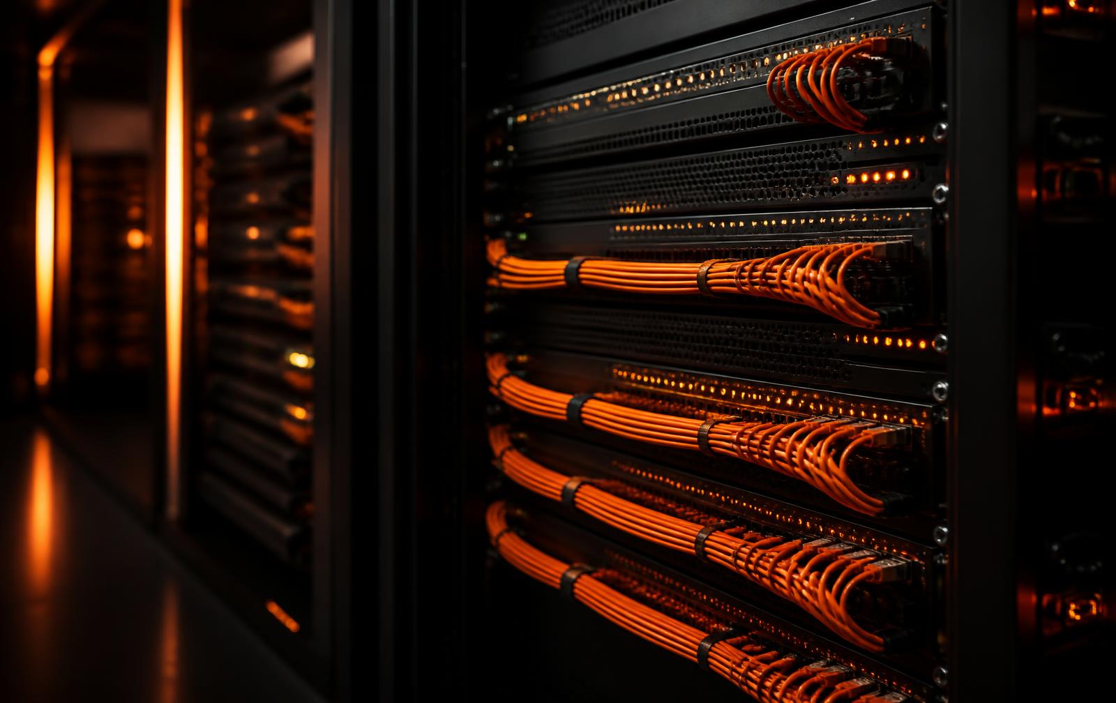Enterprise-grade network rack with neatly bundled orange patch cables